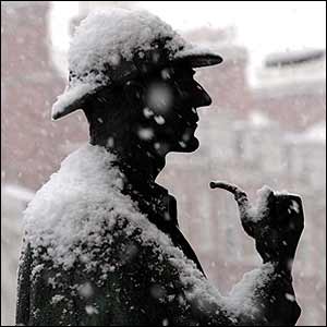 Statue of Sherlock Holmes covered in snow
