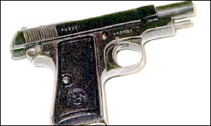 REAL - it's a Beretta 9mm pistol
