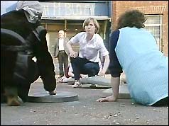 Women clang dustbin lids on the road to mark Francis Hughes' death