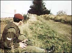 A soldier detonates a controlled explosion on a border road
