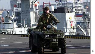 Military quad bikes being stacked on the deck of the Ark Royal