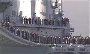 Troops wave as the Ark Royal sets sail from Portsmouth