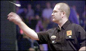 Ritchie Davies of Wales lets go of a dart