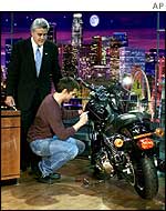 Tom Cruise signs Jay Leno's Harley-Davidson for an e-bay auction