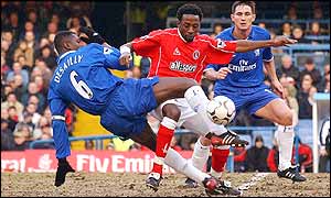 Chelsea and Charlton players in action on the muddy Stamford Bridge pitch