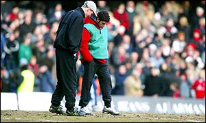 Chelsea groundstaff inspect the pitch