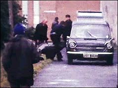 Bodies are put in the back of a van at the scene of the shooting