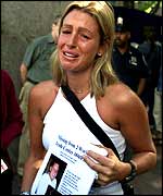 A woman searches for a loved one lost in the WTC