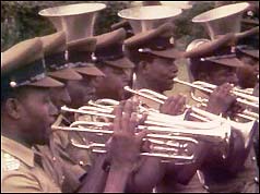 Army band practice the British national anthem ahead of Lord Soames' arrival