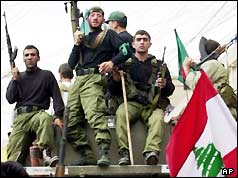Hezbollah guerillas enter a town on a tank 