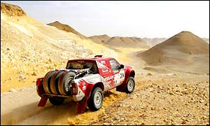 Finland's Ari Vatanen steers his Nissan pick-up to victory on stage 13 but France's Stephane Peterhansel