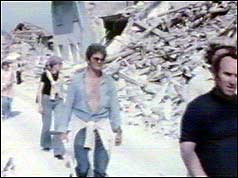 Residents break from clearing rubble