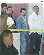 Visitors queue outside an INS office