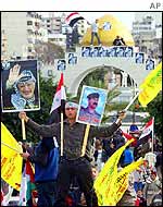 Gaza protester with portraits of Arafat and Saddam 