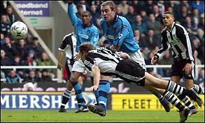 Newcastle's Craig Bellamy's flying header goes just wide of the Man City goal