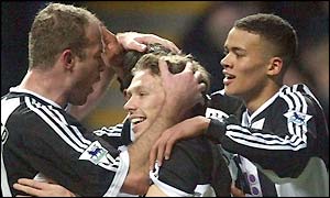 Craig Bellamy is mobbed by his team-mates