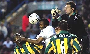 West Brom keeper Russell Hoult (right) punches the ball off the head of Lucas Radebe
