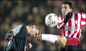 Stephane Henchoz takes a kick in the head as he tries to clear the ball from Fabrice Fernandes
