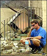 Phil Bates outside his fire-destroyed home