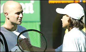 Andre Agassi shakes hands at the net with Guillermo Coria