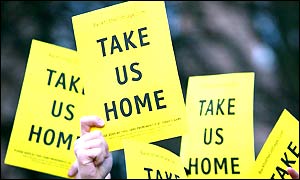 Fulham fans wave leaflets saying 