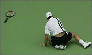 Lleyton Hewitt lies on the floor as another point is lost