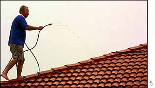 Home-owner sprays his roof with water 