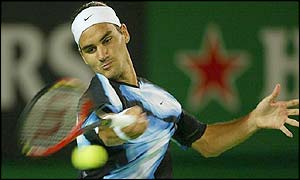 Roger Federer hits a forehand return