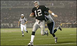 Quarterback Rich Gannon of the Oakland Raiders stretches into the end zone for a touchdown 