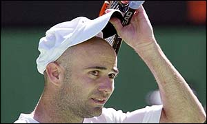 Andre Agassi lifts his cap in the Melbourne heat