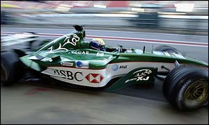 The Jaguar car drives out of the pit-lane during a testing run