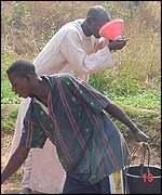 Water hawker drinks at well 