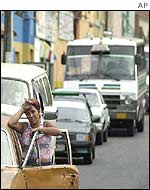 Woman waits in queue for gasoline