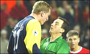 Liverpool keeper Chris Kirkland is lucky not to be sent off for a foul on Wayne Allison