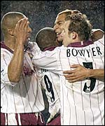 Edouard Cisse is mobbed by his West Ham team-mates after scoring the opener