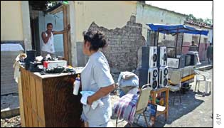A woman prepares baby milk on the street