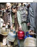 Pakistanis queue at a liquid gas shop in Lahore