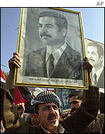 Supporter of the Iraq leader holds his portrait at rally