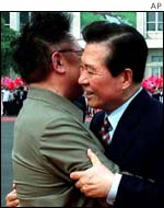 South Korean President Kim Dae-Jung, right, is embraced by North Korean leader Kim Jong-iI 