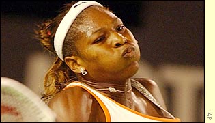 Serena Williams hits a powerful forehand return to her sister Venus