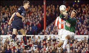 Francis Jeffers heads Arsenal's third past the Farnborough keeper Tony Pennock