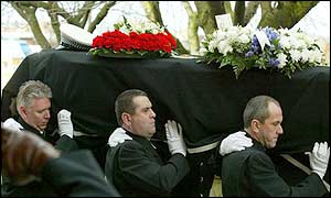 Pall bearers carrying Stephen Oake's coffin