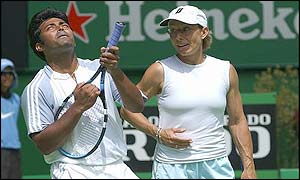 Leander Paes jokingly uses his racket as a mock gun to shoot into the sky