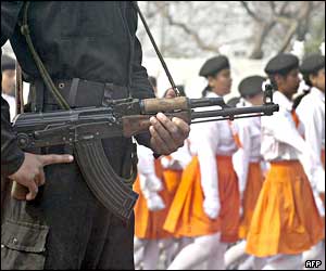 Security force personnel stand guard while school children march during Republic Day celebrations in Calcutta