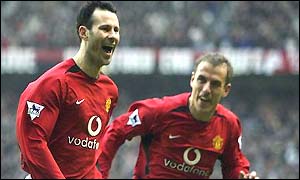 Ryan Giggs celebrates his first goal with Phil Neville