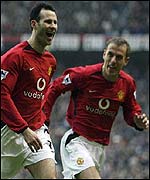 Ryan Giggs celebrates with fellow goalscorer Phil Neville