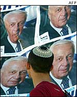 Jewish boy looks at election poster of Ariel Sharon