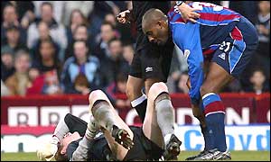 Chris Kirkland lies injured as Dele Adebola tries to help