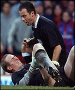 Liverpool goalkeeper Chris Kirkland is helped by referee Rob Stiles after suffering an injury at Crystal Palace