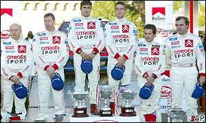 Sebastien Loeb (centre) and his co-driver stand on the top step of the podium flanked by team mates Colin McRae and Carlos Sainz and their co-drivers